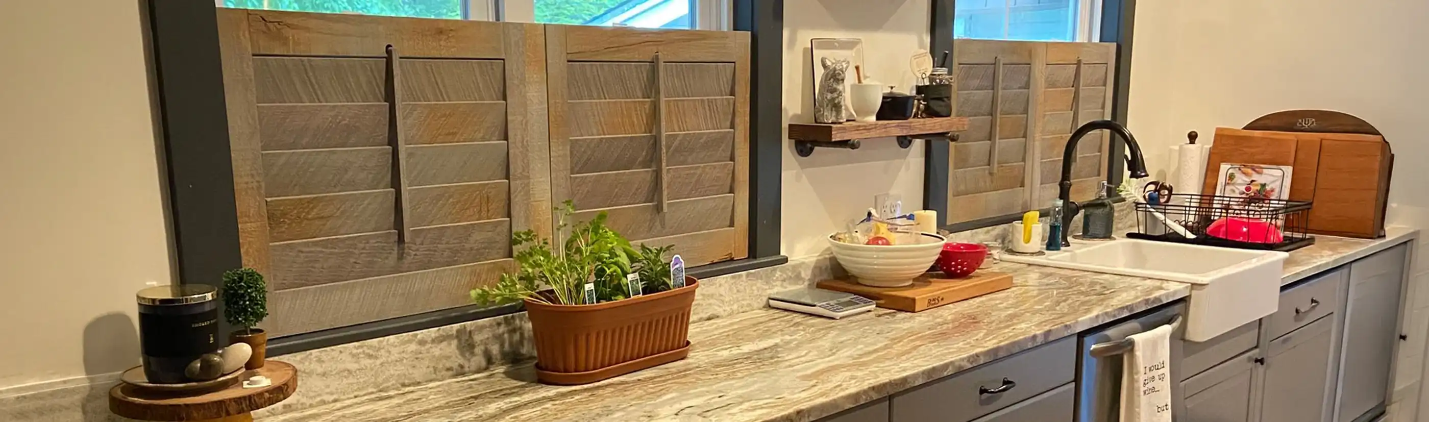 Reclaimed wood shutter windows of three different rooms of a house.