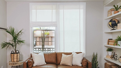 White tumble shades on a large living room window