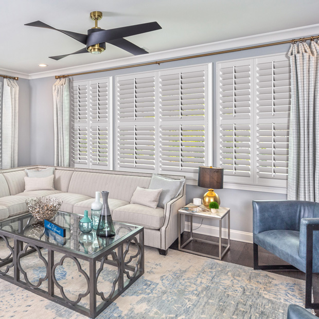 Wide windows with white plantation shutters