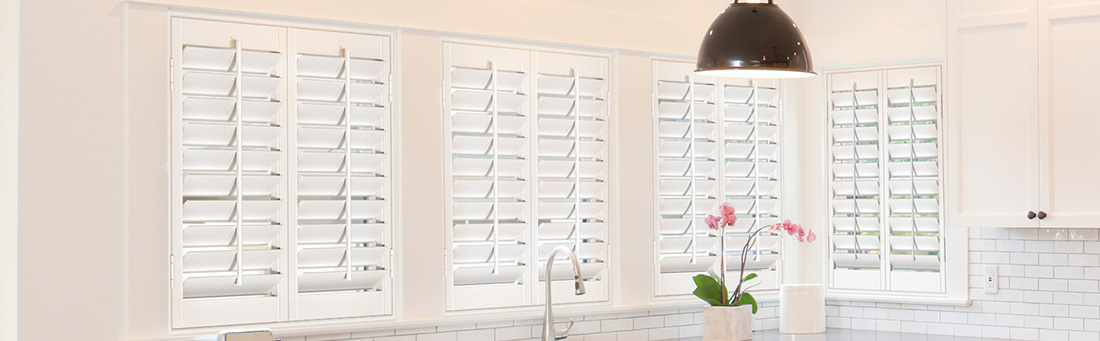 Modern kitchen with several white Polywood shutter windows