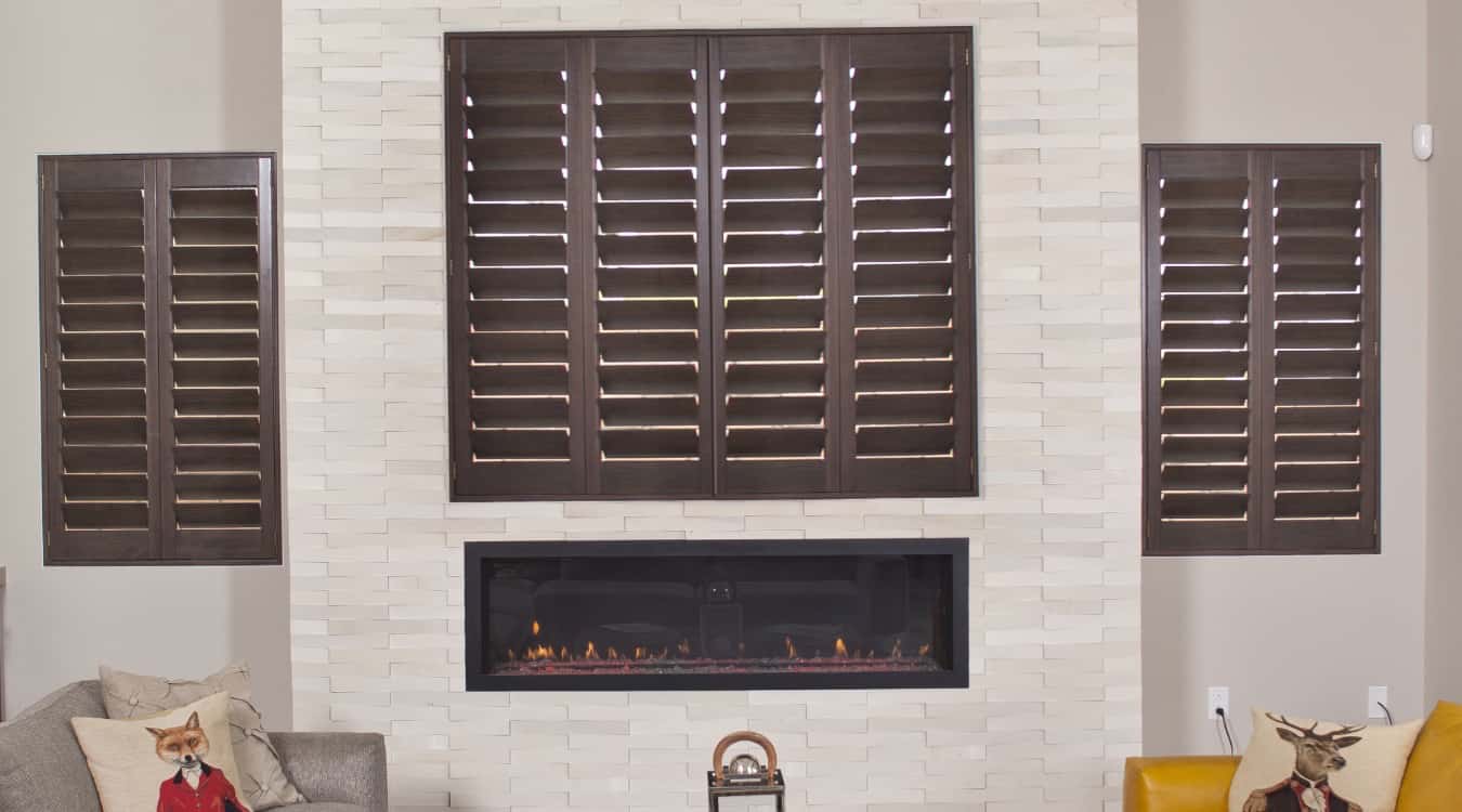 Hardwood shutters in living room with fireplace