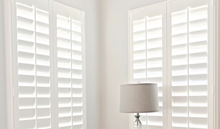 Plantation shutters come in a multitude of neutral whites and wood stains. Plantation shutters in a corner window.
