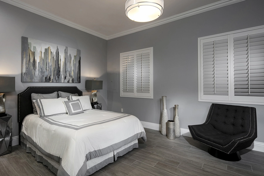 Close your custom Polywood shutters to beat the heat and keep your Orlando bedroom cool. White Polywood shutters on bedroom windows