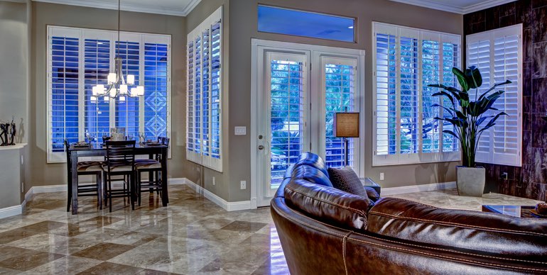 Photo Courtesy of Room Resolutions Orlando great room with white shutters and modern lighting.