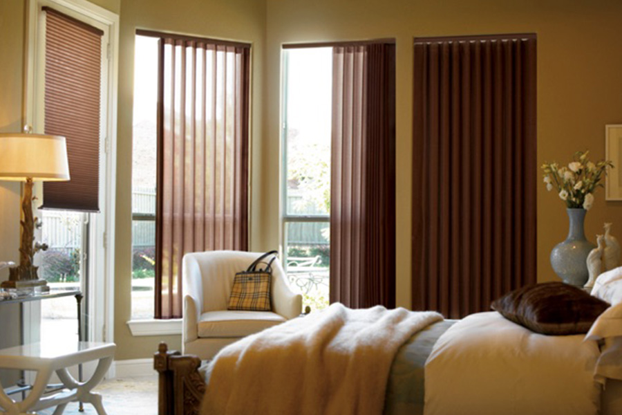 Choose durable and high-quality fabric or vinyl vertical blinds in Orlando. Maroon fabric vertical blinds inside a bedroom