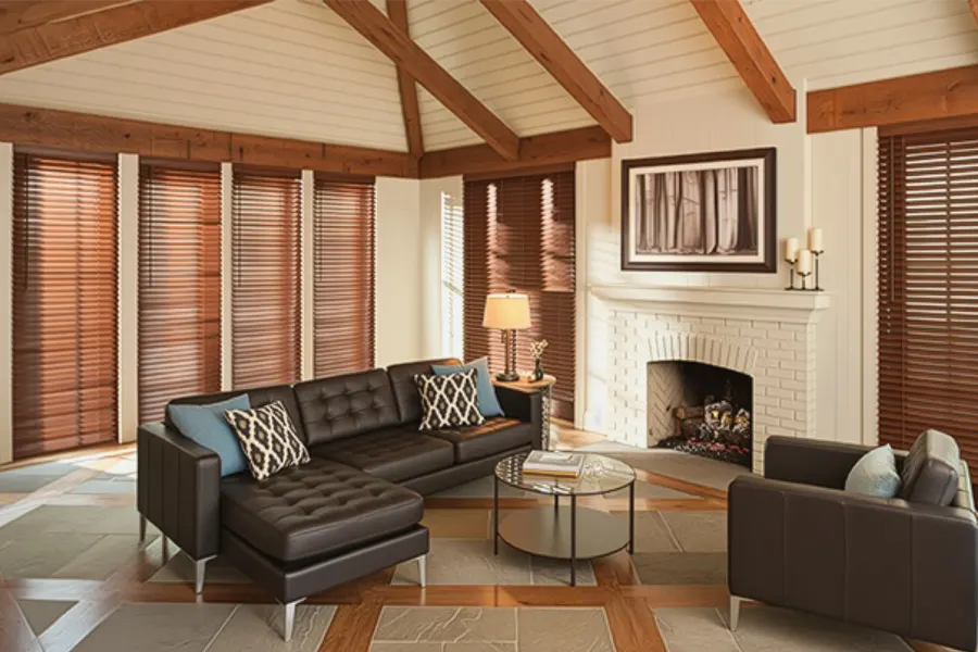 Craftsman homes use natural materials and fine workmanship to create a homey atmosphere. A living room with exposed wood beams, fireplace, and wood blinds on tall windows
