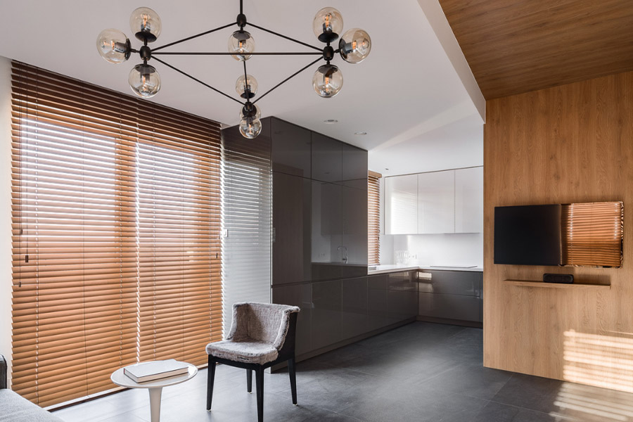 Wood blinds are the perfect combination of functionality and visual appeal. Brown wood blinds on a large window in a modern home