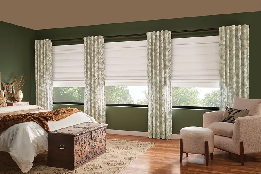 Fabric window treatments are an easy way to add complementary color and pattern to Craftsman home. Green drapes and white shades on bedroom windows