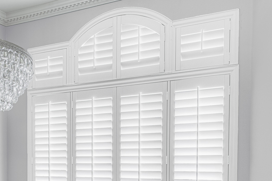 Customize your Palladian windows with white Polywood shutters in Orlando. White Polywood Palladian windows in a dining room.