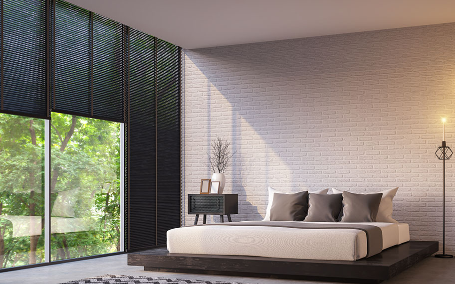 Get sleek lines when you choose roller shades vs. cellular shades in Orlando. roller shade in a modern bedroom