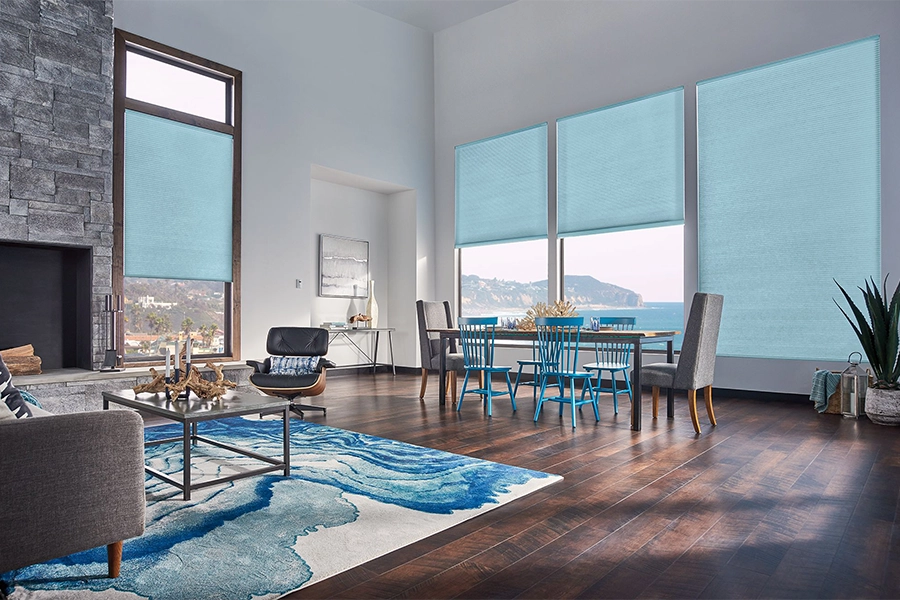 Smart motorized window shades are perfect on tall windows in your Orlando home. Blue motorized shades on tall living room windows