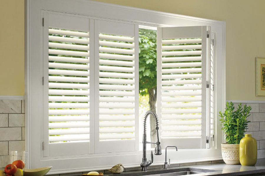 Polywood shutters are built to withstand the test of time in Orlando. White Polywood shutters above a kitchen sink.